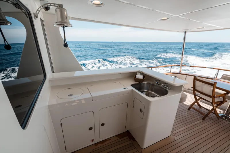Rat Pack Yacht Photos Pics Luxury yacht deck with sink and seating, Marlow Explorer 2011, cruising on open sea.