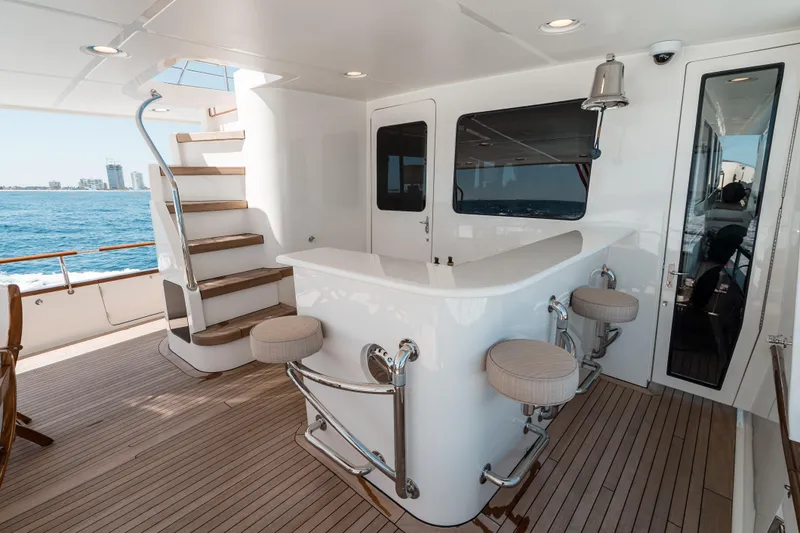 Rat Pack Yacht Photos Pics Luxurious 2011 Marlow Explorer yacht deck with bar, stools, and ocean view.