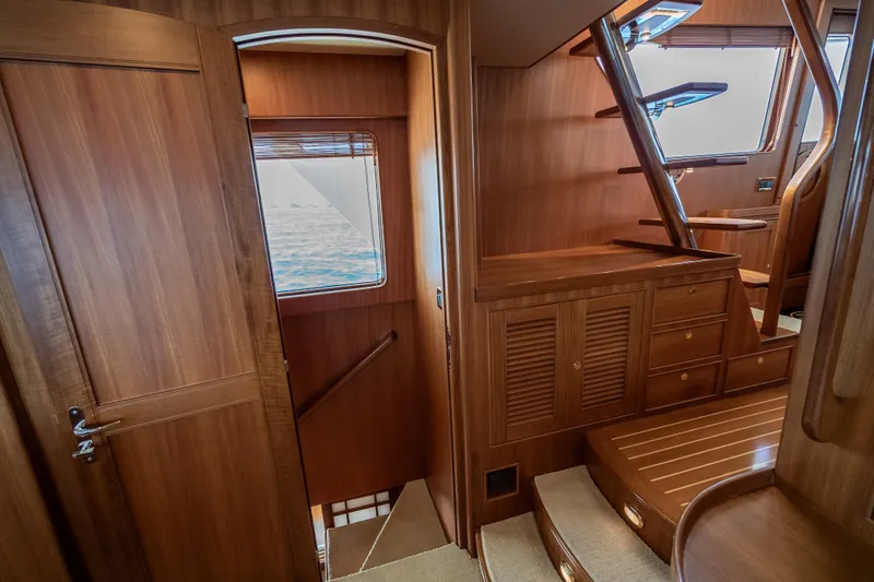 Rat Pack Yacht Photos Pics Luxurious wooden interior of 2011 Marlow Explorer yacht with stairs and window view.