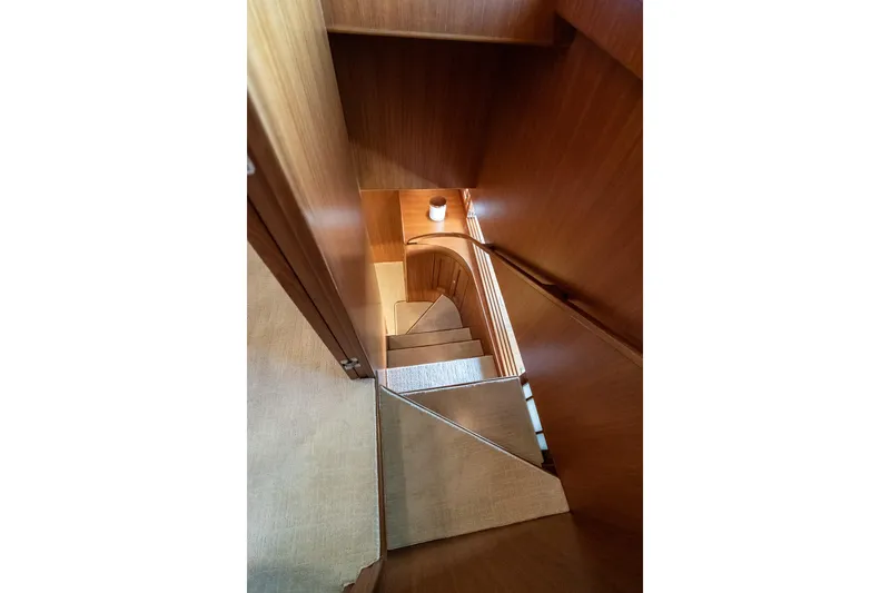 Rat Pack Yacht Photos Pics Wooden staircase inside 2011 Marlow Explorer yacht, featuring elegant design and craftsmanship.