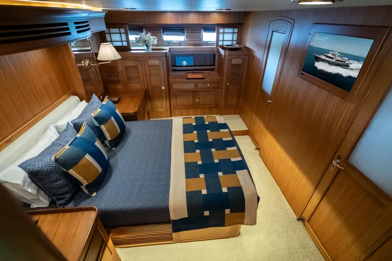 Rat Pack Yacht Photos Pics Luxurious cabin interior of 2011 Marlow Explorer yacht with elegant wood finish and cozy bedding.
