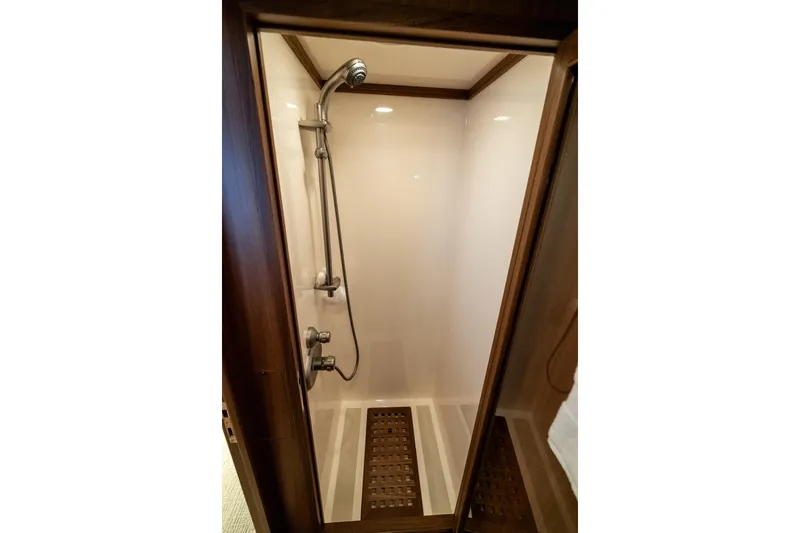 Rat Pack Yacht Photos Pics Shower area in 2011 Marlow Explorer yacht with wooden accents and modern fixtures.