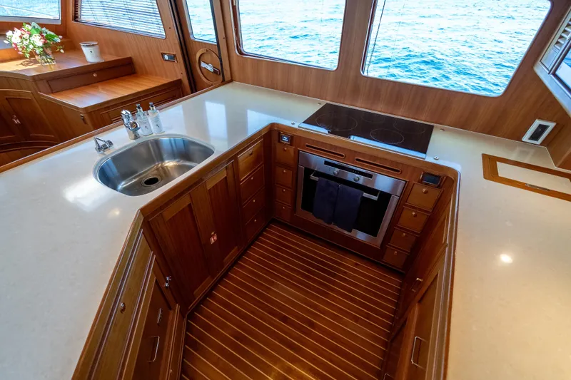 Rat Pack Yacht Photos Pics Luxurious 2011 Marlow Explorer yacht kitchen with wood cabinetry and ocean view.
