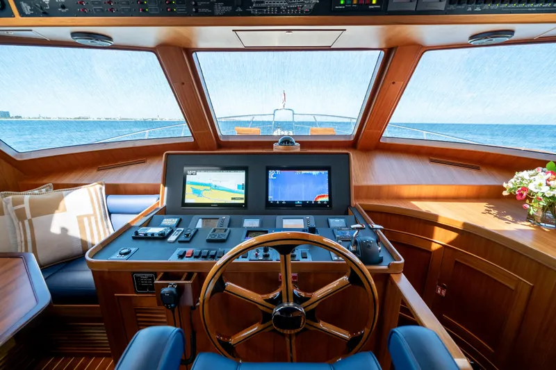 Rat Pack Yacht Photos Pics Helm of 2011 Marlow Explorer yacht with navigation screens and wooden steering wheel.