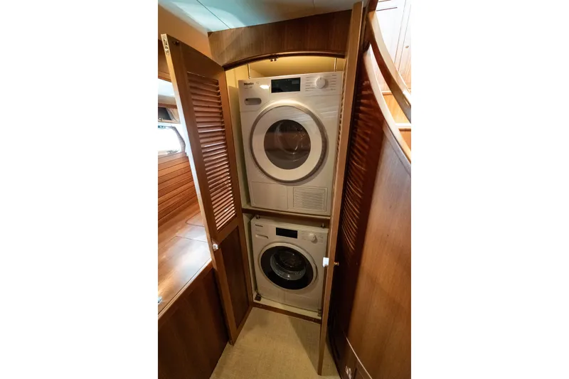 Rat Pack Yacht Photos Pics Laundry area with stacked washer and dryer in 2011 Marlow Explorer yacht.