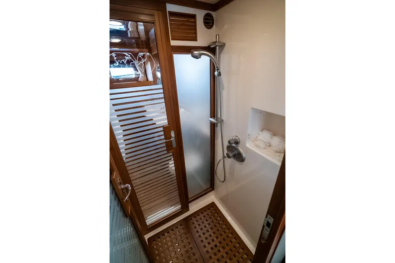 Rat Pack Yacht Photos Pics Luxurious shower in 2011 Marlow Explorer yacht with wooden accents and modern fixtures.