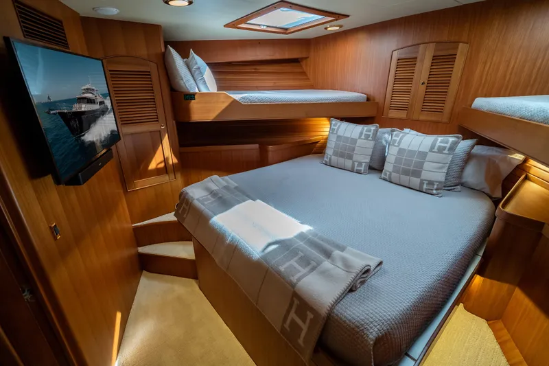 Rat Pack Yacht Photos Pics Luxurious 2011 Marlow Explorer yacht cabin with cozy bedding and elegant wood finishes.