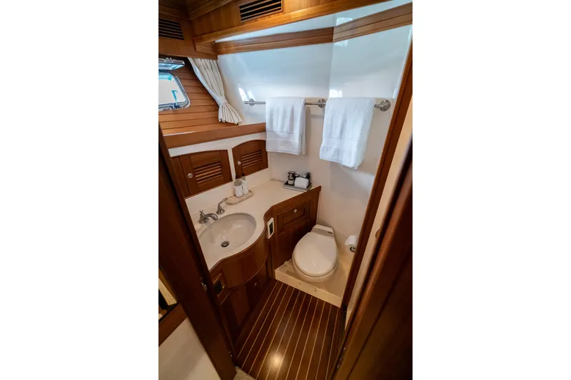 Rat Pack Yacht Photos Pics Luxurious 2011 Marlow Explorer yacht bathroom with wooden accents and modern amenities.