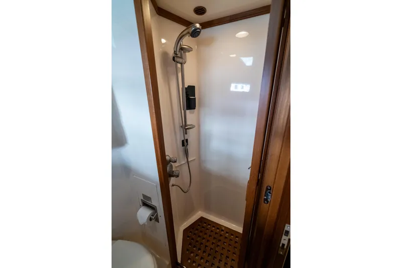 Rat Pack Yacht Photos Pics Shower area in 2011 Marlow Explorer yacht with wooden accents and modern fixtures.