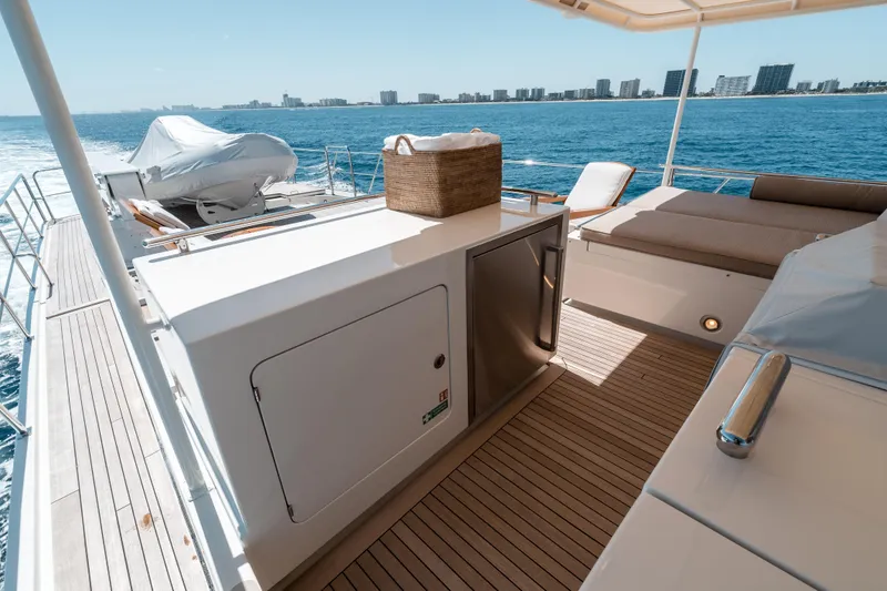 Rat Pack Yacht Photos Pics Luxurious 2011 Marlow Explorer yacht deck with seating, ocean view, and city skyline.