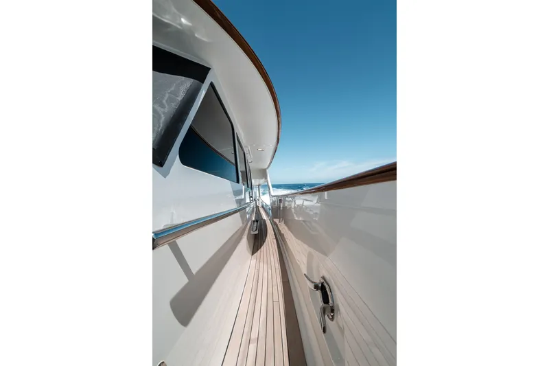 Rat Pack Yacht Photos Pics Side view of 2011 Marlow Explorer yacht with wooden deck and clear blue sky.