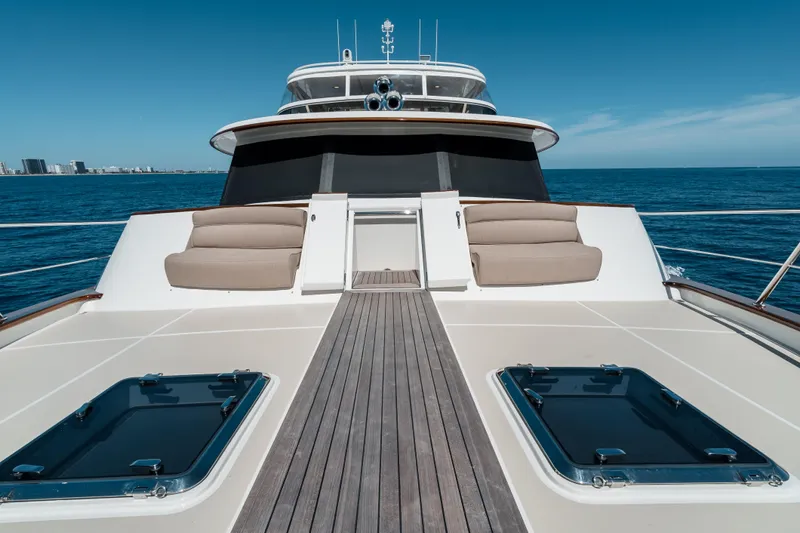Rat Pack Yacht Photos Pics 2011 Marlow Explorer yacht deck with seating, cruising on open sea under clear blue sky.