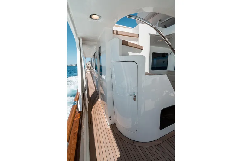 Rat Pack Yacht Photos Pics Side deck of 2011 Marlow Explorer yacht with wooden flooring and ocean view.