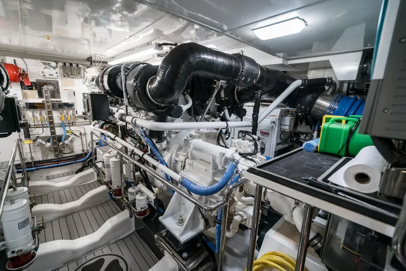 Rat Pack Yacht Photos Pics Engine room of a 2011 Marlow Explorer yacht, showcasing complex machinery and equipment.