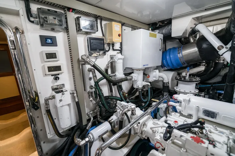 Rat Pack Yacht Photos Pics Engine room of a 2011 Marlow Explorer yacht, showcasing complex machinery and piping systems.