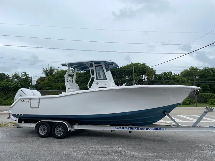  Yacht Photos Pics 2026 Tidewater 282 CC Adventure boat on trailer, side view, outdoors.
