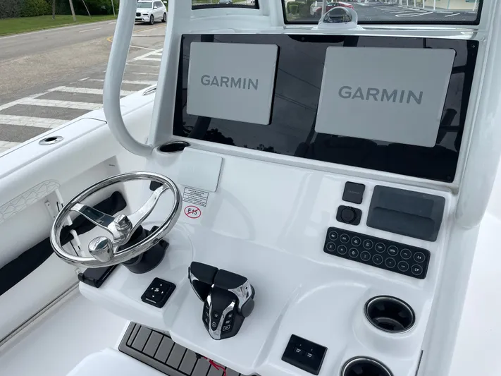  Yacht Photos Pics 2026 Tidewater 282 CC Adventure boat dashboard with dual Garmin displays and steering wheel.