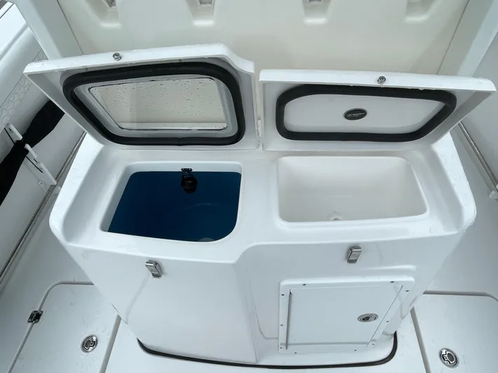  Yacht Photos Pics 2026 Tidewater 282 CC Adventure boat storage compartments, open with visible interior.