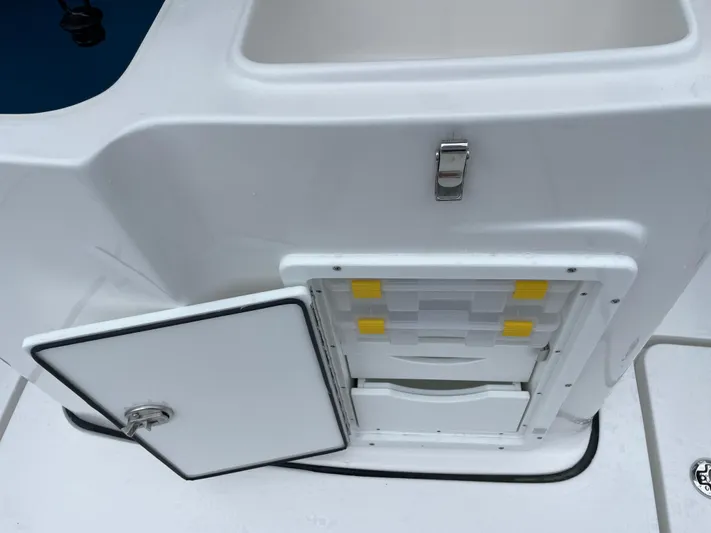  Yacht Photos Pics 2026 Tidewater 282 CC Adventure boat storage compartment with open hatch and latch.