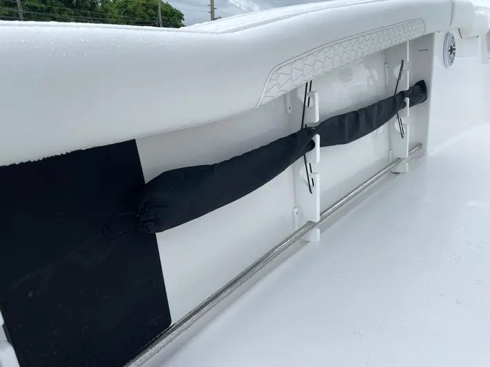  Yacht Photos Pics 2026 Tidewater 282 CC Adventure boat interior detail with rod holders and cushioned side panel.