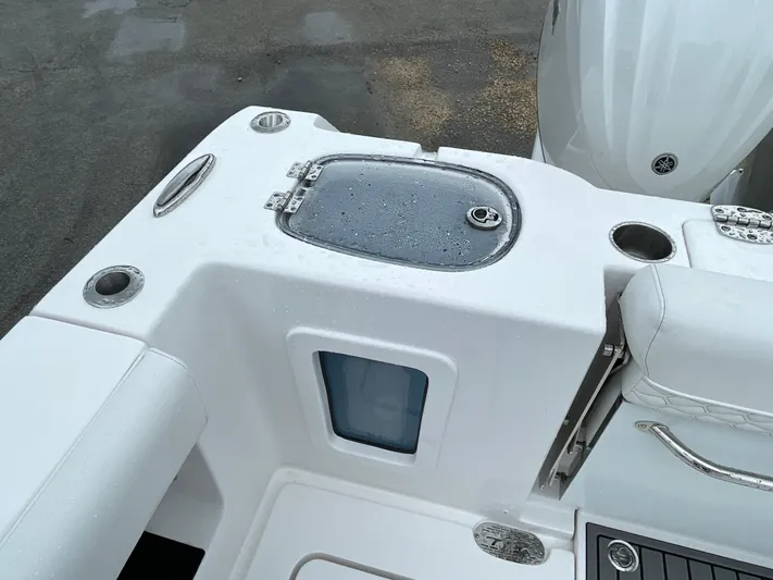  Yacht Photos Pics 2026 Tidewater 282 CC Adventure boat deck with storage and seating.