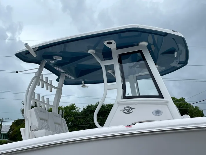  Yacht Photos Pics 2026 Tidewater 282 CC Adventure boat with sleek T-top design against cloudy sky.