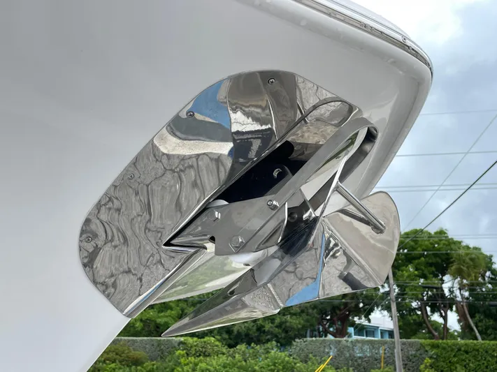  Yacht Photos Pics Stainless steel anchor on 2026 Tidewater 282 CC Adventure boat, against cloudy sky backdrop.