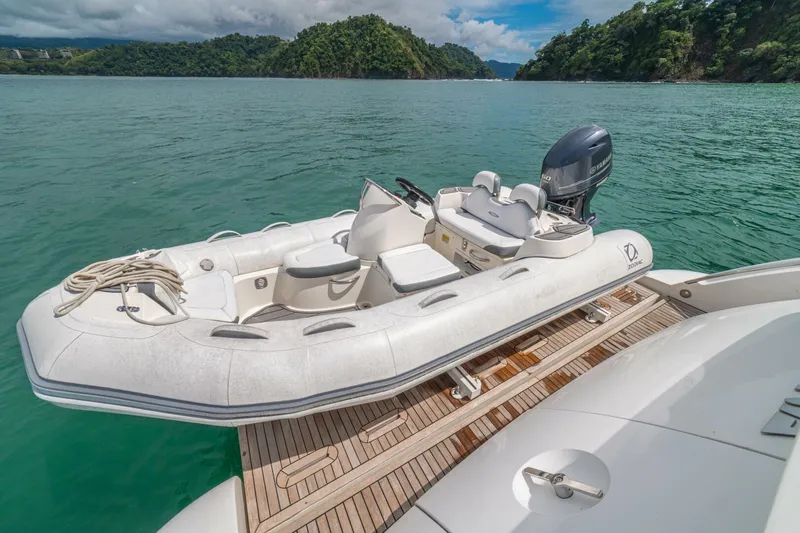 Costa Luna Yacht Photos Pics Inflatable boat on Azimut 64 yacht, 2014 model, docked on serene water with lush green backdrop.