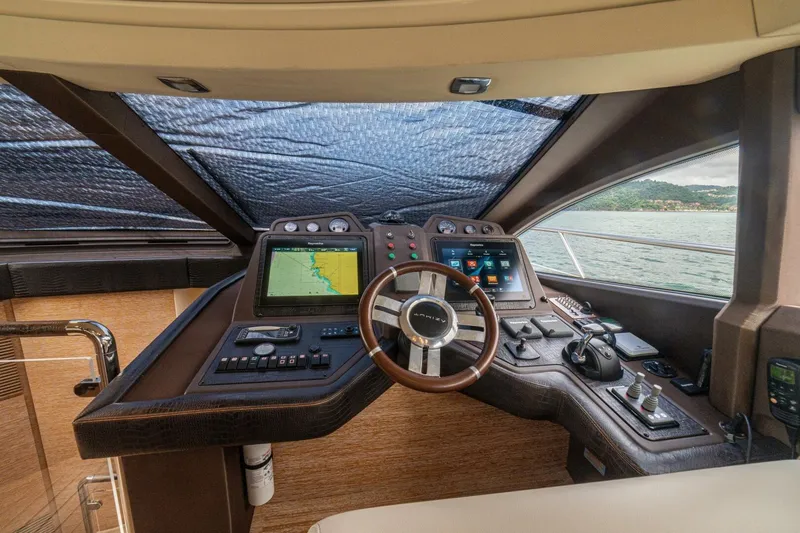 Costa Luna Yacht Photos Pics Interior helm of 2014 Azimut 64 yacht with navigation screens and steering wheel.