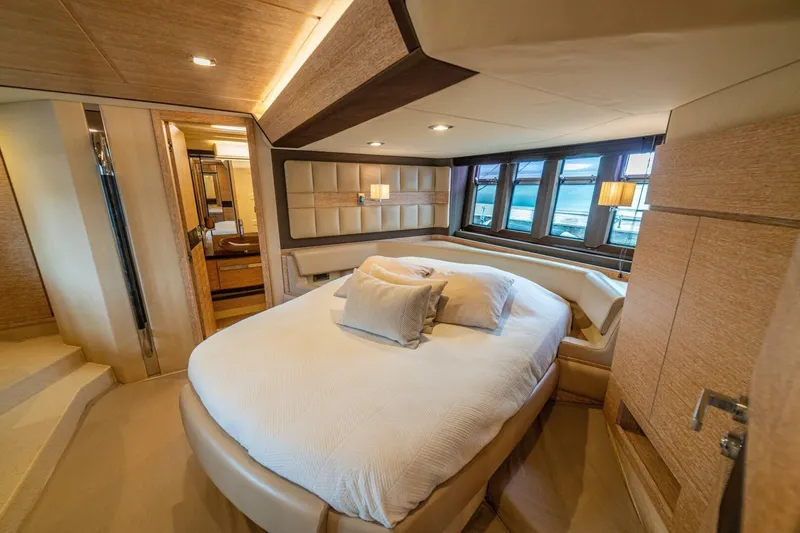 Costa Luna Yacht Photos Pics Luxurious bedroom interior of 2014 Azimut 64 yacht with elegant design and large windows.