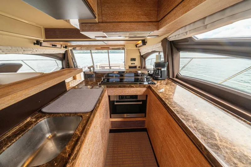 Costa Luna Yacht Photos Pics Luxurious kitchen interior of 2014 Azimut 64 yacht with marble countertops and modern appliances.