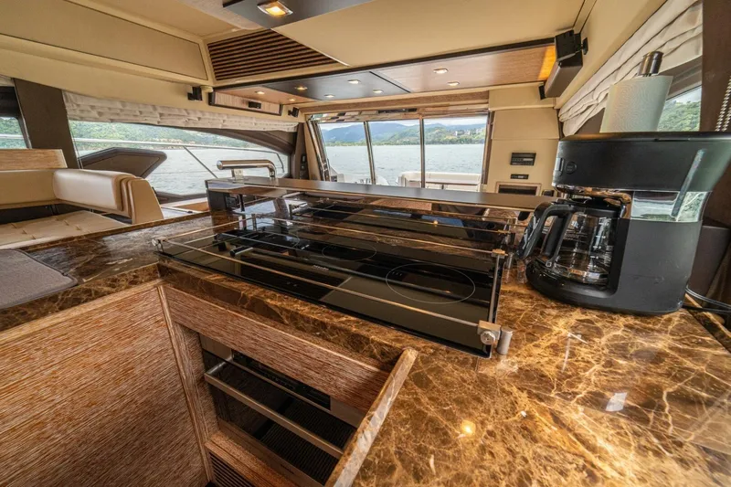 Costa Luna Yacht Photos Pics Luxurious kitchen interior of 2014 Azimut 64 yacht with marble countertops and modern appliances.