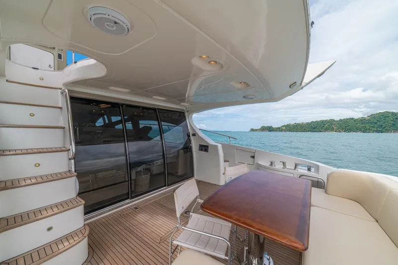Costa Luna Yacht Photos Pics Luxurious 2014 Azimut 64 yacht deck with seating, table, and ocean view.