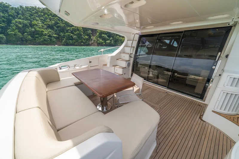 Costa Luna Yacht Photos Pics Luxurious 2014 Azimut 64 yacht deck with seating, table, and scenic ocean view.