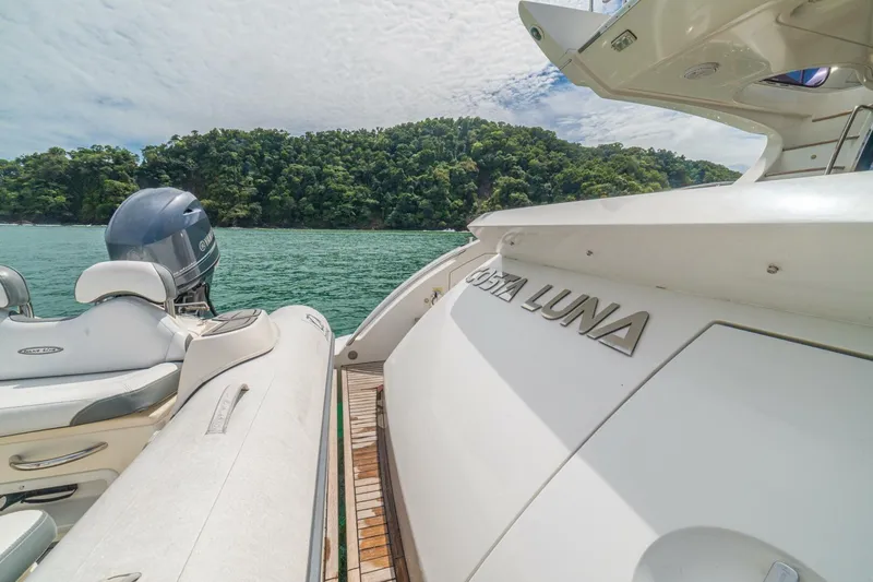 Costa Luna Yacht Photos Pics 2014 Azimut 64 yacht "Costa Luna" docked near lush green island.