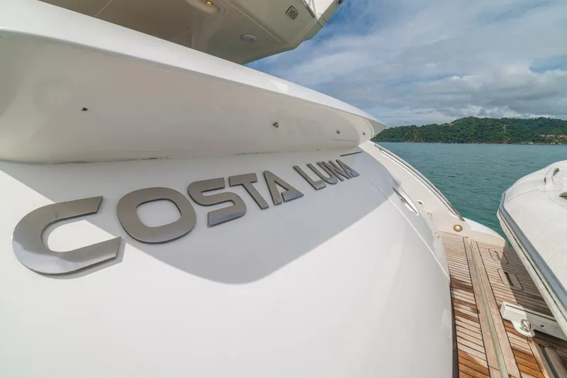 Costa Luna Yacht Photos Pics 2014 Azimut 64 yacht "Costa Luna" docked by scenic coastline.