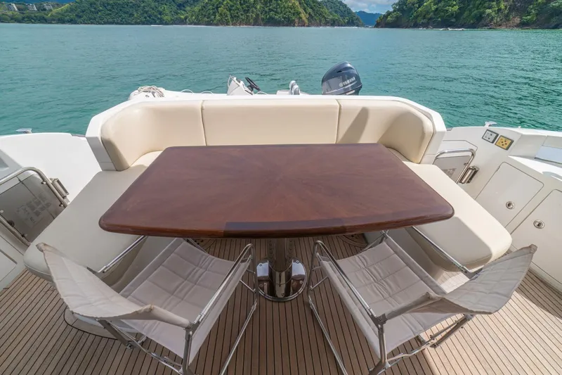 Costa Luna Yacht Photos Pics Luxury Azimut 64 yacht deck with table and chairs, 2014 model, scenic ocean view.