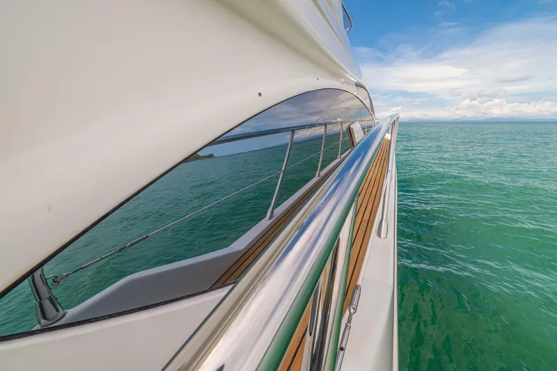 Costa Luna Yacht Photos Pics Side view of 2014 Azimut 64 yacht cruising on turquoise sea.