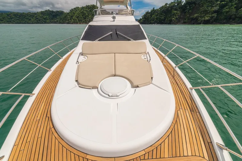 Costa Luna Yacht Photos Pics Luxurious 2014 Azimut 64 yacht with teak deck and sunbed on serene waters.