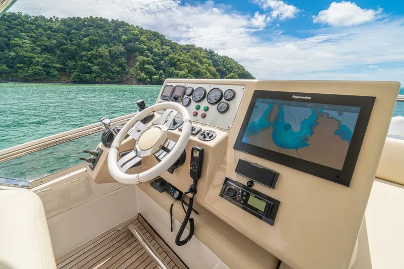 Costa Luna Yacht Photos Pics Cockpit of 2014 Azimut 64 yacht with navigation system, steering wheel, and scenic ocean view.