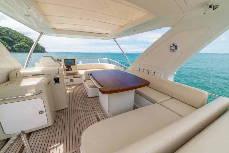 Costa Luna Yacht Photos Pics Luxurious 2014 Azimut 64 yacht interior with ocean view, featuring elegant seating and wooden table.