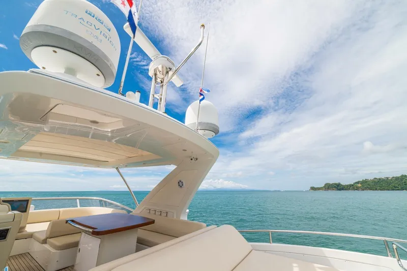 Costa Luna Yacht Photos Pics Luxurious 2014 Azimut 64 yacht with spacious deck, ocean view, and clear blue sky.