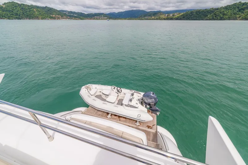 Costa Luna Yacht Photos Pics Luxury Azimut 64 yacht with tender, 2014 model, on serene water with lush green hills.