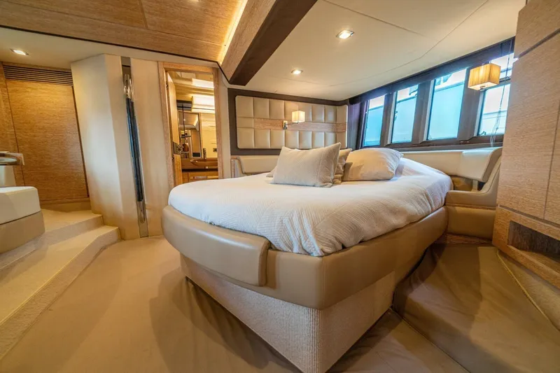 Costa Luna Yacht Photos Pics Luxurious bedroom interior of 2014 Azimut 64 yacht with elegant furnishings and ambient lighting.