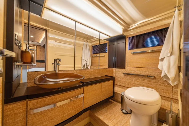 Costa Luna Yacht Photos Pics Luxurious bathroom interior of 2014 Azimut 64 yacht with modern fixtures and wood accents.