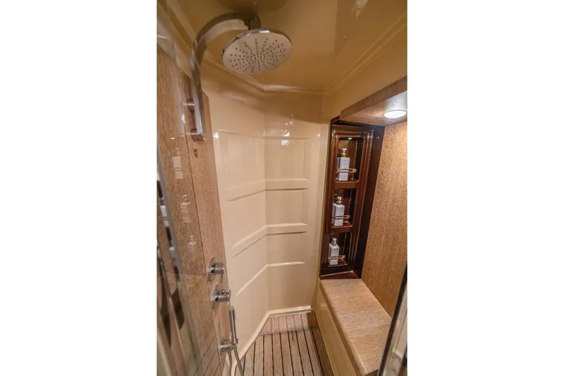 Costa Luna Yacht Photos Pics Luxurious shower in 2014 Azimut 64 yacht with modern fixtures and built-in shelving.