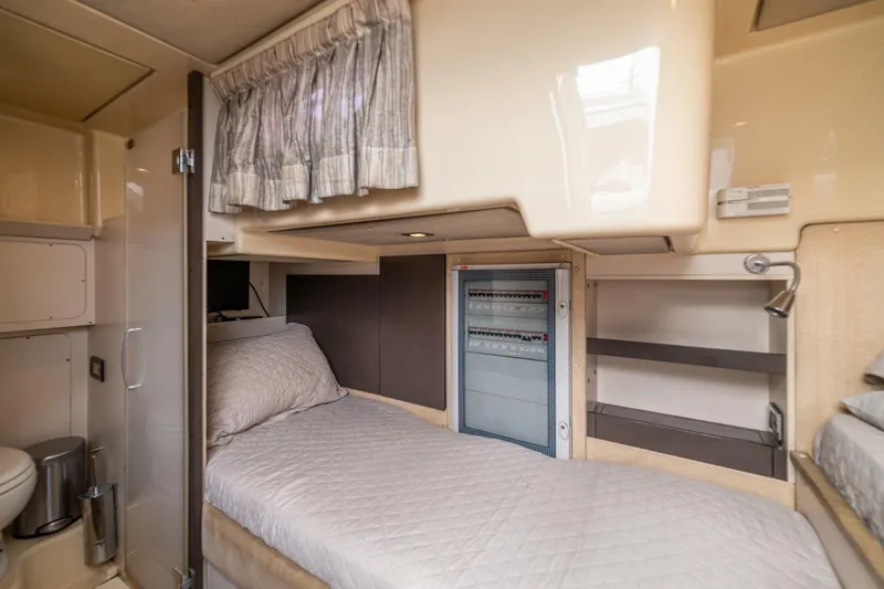 Costa Luna Yacht Photos Pics 2014 Azimut 64 yacht interior cabin with bed, shelves, and control panel.