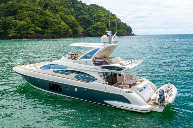 Costa Luna Yacht Photos Pics Luxurious 2014 Azimut 64 yacht cruising in tropical waters near lush green island.