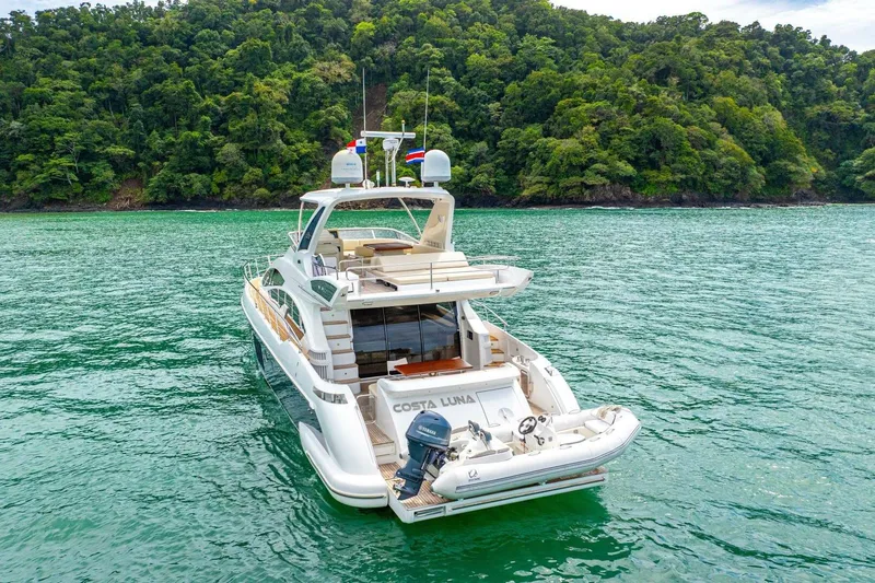 Costa Luna Yacht Photos Pics Luxury 2014 Azimut 64 yacht on serene waters near lush green coastline.