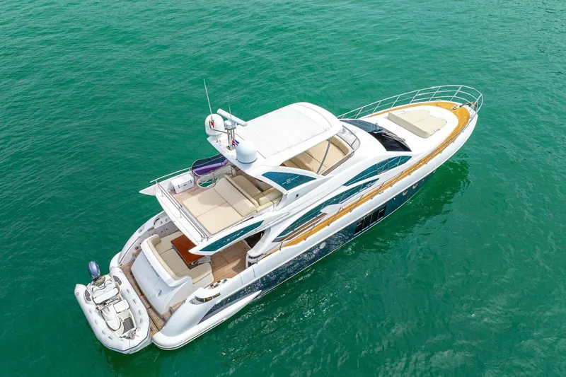 Costa Luna Yacht Photos Pics Luxurious 2014 Azimut 64 yacht cruising on clear turquoise waters.